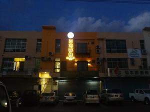 a building with a neon sign in front of it at SUNBAY INN in Semporna