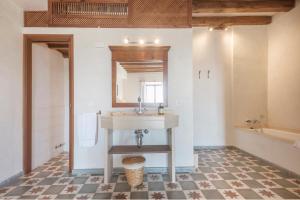 a bathroom with a sink and a mirror at Sa Bisbal - Turismo de interior in Selva