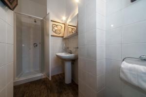 bagno bianco con lavandino e doccia di Casa da Suite Classica a Milano