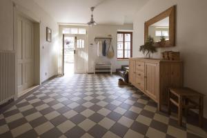 a hallway with a mirror and a checkered floor at Vikendovka Korce in Dubá