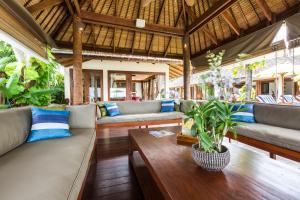 a living room with couches and a table at Baan Mika in Bophut 