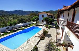 a large swimming pool in front of a house at Marigoula Village in Skopelos Town