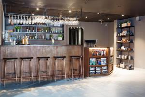 a bar in a restaurant with bar stools at Comfort Hotel Bergen in Bergen