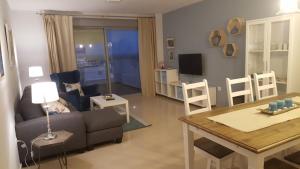 a living room with a couch and a table at APART.CON PISCINA VISTASOL in Conil de la Frontera