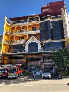 a large building with cars parked in front of it at ASHBURN'S TRANSIENT BAGUIO - BASIC and BUDGET SLEEP and GO Accommodation, SELF SERVICE in Baguio