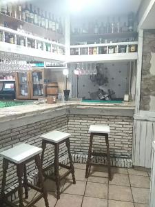 dois bancos sentados em frente a um bar em Casa Favila em Potes