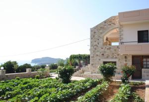 a villa with a garden in front of a building at Romantica Apartments in Falasarna