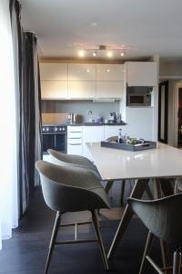 una cocina con mesa y sillas. en Parkhotel Heidehof Long Stay, en Ingolstadt