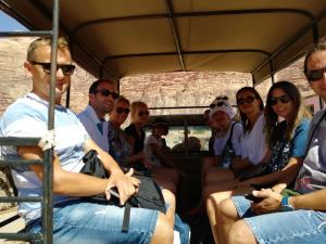 un grupo de personas sentadas en un autobús en Wadi Rum Excursions, en Wadi Rum 4 fotos más