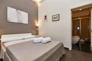 Postel nebo postele na pokoji v ubytování Donna Teresa Guest House
