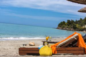 a beach with a tent and a table on the beach at Olympion Sunset Halkidiki in Fourka