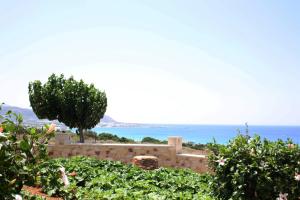 a retaining wall with a view of the ocean at Romantica Apartments in Falasarna
