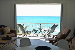 a living room with a view of the ocean at SitgesNow Port Alegre Mar in Sitges