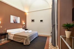 Postel nebo postele na pokoji v ubytování Donna Teresa Guest House