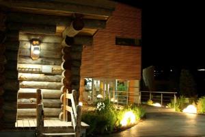 a house with lights on the side of it at night at Hotel-Pension Haus Hubertus in Weigendorf