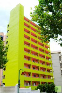 a yellow building with a yellow roof at Now Benidorm in Benidorm