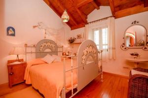 a bedroom with a bed and a table and a mirror at Apartments Peric in Igrane