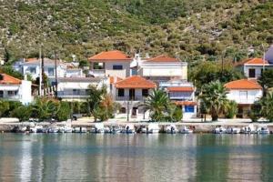 a group of houses with boats in the water at Selene's House in Skala Kallirachis