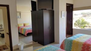 a bedroom with a large cabinet and a bed at Suites Lagunas in Colima