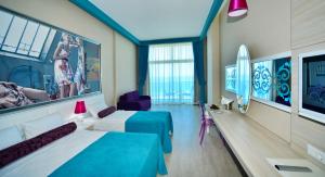 a hotel room with two beds and a large window at Sultan of Dreams Hotel & Spa in Kızılot