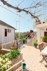 a patio with a table and chairs on a house at Apartment Anic in Stari Grad