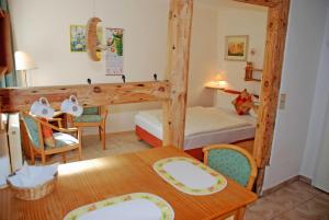 a small room with a bunk bed and a table at Appartementhaus zur Brücke direkt am See in Sandort