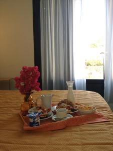 a tray of food on top of a bed at Hotel Aura in Vulcano