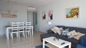 a living room with a couch and a table at APART.CON PISCINA VISTASOL in Conil de la Frontera