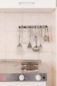 a kitchen with utensils hanging on the wall at Apartment Anic in Stari Grad