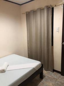 Postel nebo postele na pokoji v ubytování Edem Tourist Inn Malapascua
