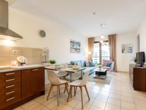 a kitchen and living room with a table and chairs at VacationClub – Olympic Park Apartament B402 in Kołobrzeg