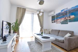 a living room with a couch and a table at Apartment Bojana in Budva