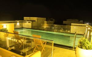 a swimming pool on the roof of a building at Petit Palais in Puducherry