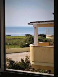 uma vista para o oceano a partir de uma janela em Multi Vacanza La Ciaccia em Valledoria
