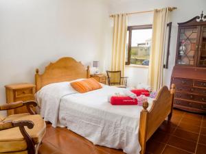 a bedroom with a bed and a dresser and a window at Villa Vila Hortencia by Interhome in Ericeira