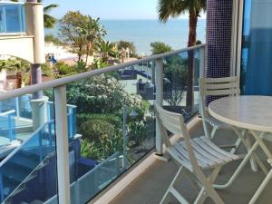 a balcony with a table and chairs and the ocean at Apartment Playasol 1 by Interhome in Les Cases d'Alcanar