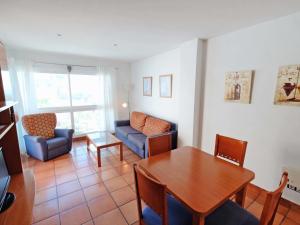 a living room with a table and a couch at Apartment Playasol 1 by Interhome in Les Cases d'Alcanar