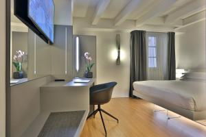 a hotel room with a bed and a desk at Urban Hotel Design in Trieste