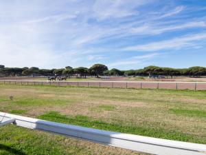 a field with a fence and horses in a race track at Villa Les Pesquiers by Interhome in Hyères