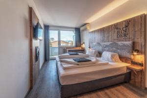 a bedroom with two beds and a large window at BinderS Budget City-Mountain Hotel in Innsbruck