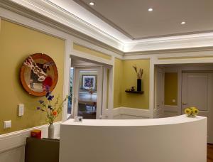 a room with yellow walls and a counter with flowers at Hotel Imperial in Amsterdam