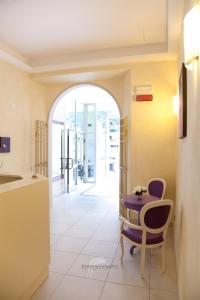 a kitchen with a table and chairs in a room at Albergo Roma in Borgo Val di Taro