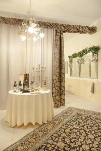 um quarto branco com uma mesa e um lustre em Albergo Roma em Borgo Val di Taro