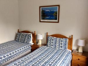 Tempat tidur dalam kamar di Dalkell Cottage