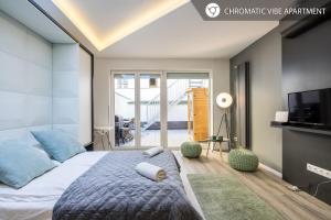 a bedroom with a large bed and a tv at BpR Elite Apartments - Sky Terrace in Budapest