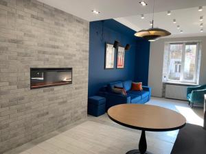 a living room with a table and a fireplace at Дизайнерські апартаменти на вулиці Краківській 17 в центрі Львова in Lviv +5 photos