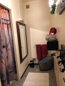 a bathroom with a mirror and red towels on the wall at Chateau Saint Claude an der Saone in Mantoche