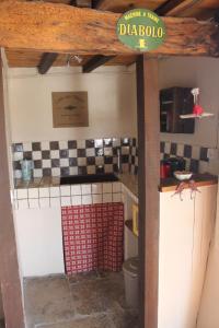 a kitchen with a sink and a toilet in a room at La Bugadière in Salles-sous-Bois