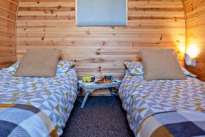 two beds sitting next to each other in a room at Howe of Torbeg in Ballater