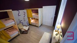 a room with two beds and a desk at InVerve Hostel in Timişoara